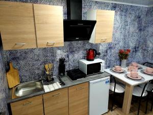 a small kitchen with a sink and a microwave at u Kapitana in Rowy