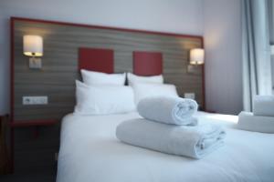 Letto o letti in una camera di Hôtel du Musée