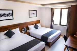 Uma cama ou camas num quarto em Robin Hotel Danang