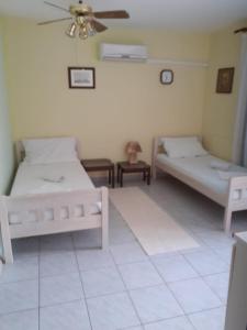 a room with two beds and a ceiling fan at Josip 2 Gajac in Novalja