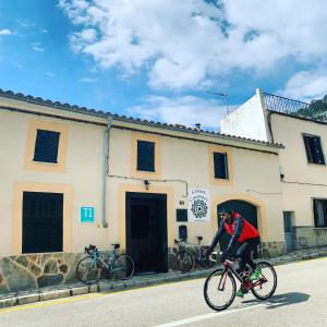 a person riding a bike down a street at Casa Caimari Guest House, for mountain lovers! in Caimari