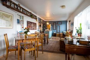 a dining room and living room with a table and chairs at Sjávarborg in Stykkishólmur