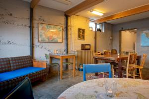 an empty restaurant with tables and chairs and tablesktop at Sjávarborg in Stykkishólmur