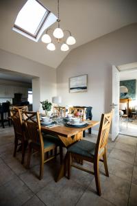 a dining room with a wooden table and chairs at Cannon Cottage in St John's Point