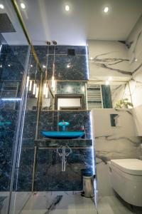 uma casa de banho com um lavatório azul e um WC. em Apartament w Cieplicach 6 Gold em Jelenia Góra