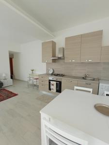 a large white kitchen with a stove top oven at CASA DI GIO in Sestri Levante