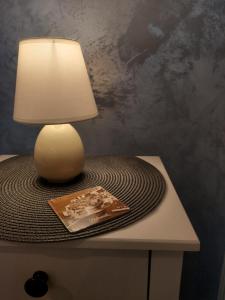 a lamp sitting on top of a table with a book at Apartment Melody in Dubrovnik