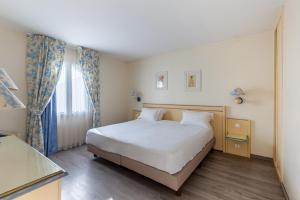 En eller flere senge i et værelse på Residhotel Golf Grand Avignon