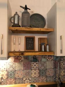 a kitchen with wooden shelves and a new day sign at Lokschuppen im alten Bahnhof Industrial Style in Moschheim