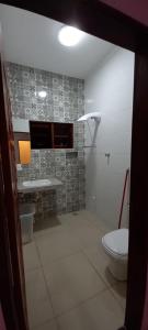 a bathroom with a toilet and a sink at Boa Vista in São Thomé das Letras