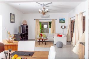 a living room with a white couch and a chandelier at 2-Bed Apt Sleeps 4 near Beau Vallon Beach in Mahe