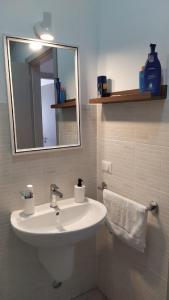 a bathroom with a white sink and a mirror at Ca'Claudia Boavista in Sal Rei +39 photos