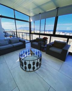 a living room with couches and a table on a building at Waves Edge CP3 in Cape Town
