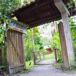 an entrance to a building with a sign on it at Pousada do Carlito in Ilha do Mel