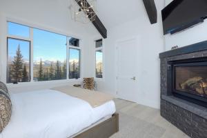 a bedroom with a bed and a fireplace at Inspiration Point Townhome 1B in Big Sky
