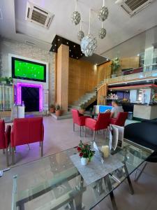 a lobby with a person sitting at a table in a restaurant at Hotel VELSATIS in Beni Mellal