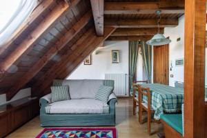 a living room with a couch and a table at Asiago Millepini - Mansarda sull'Altopiano in Asiago