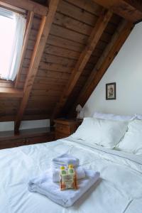 a bedroom with a bed with towels on it at Asiago Millepini - Mansarda sull'Altopiano in Asiago