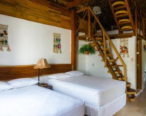 Postel nebo postele na pokoji v ubytování Xcabal Hotel boutique