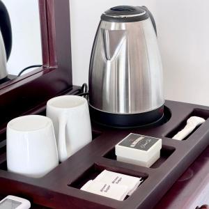 a tray with a tea pot and cups on a table at Blinkbonnie Inn in Kandy