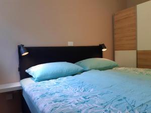 Postel nebo postele na pokoji v ubytování SočaLand Apartmaji