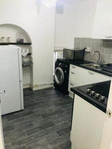 a kitchen with a washer and a washing machine at Premier Property Lettings Limited in Castle Donington