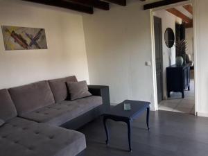 a living room with a couch and a table at Le Nichoir Lac du Der in Droyes