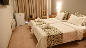 Postel nebo postele na pokoji v ubytování Hotel Xanthippion