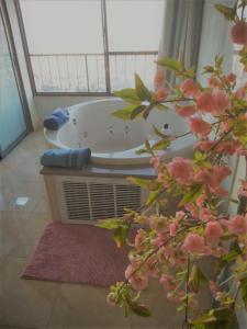 a bath tub in a bathroom with a window at Panorama Bay View 3 room in Haifa