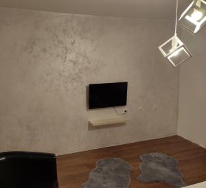 a living room with a flat screen tv on a wall at V&J apartments in Podgorica