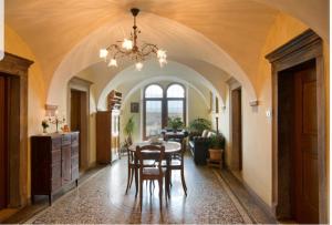 a dining room with a table and chairs in a room at Ansitz Strengherrnhof in Caldaro