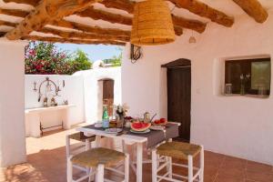 a dining room with a table and chairs at FINCA RELAX IBIZA STILE in Sant Josep de Sa Talaia