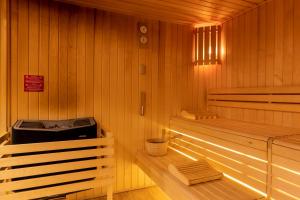 a room with a sauna with a bench in it at PADJA Hôtel & Spa Vannes in Vannes