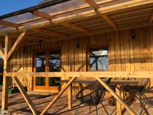 a wooden house with a table and chairs in it at Rīga Mangalsala Cottage with sauna in Riga
