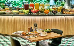 a table with food on top of a bar at Hyatt Regency Amsterdam in Amsterdam
