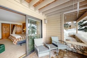 a room with a balcony with two chairs and a bedroom at Snowcreek 1580 in Sun Valley +73 photos