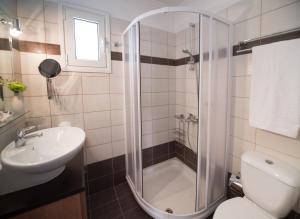łazienka z prysznicem, toaletą i umywalką w obiekcie Villa Pasithea - breathtaking seaviews, infinity pool, privacy, close to the beach w mieście Nydri +17 zdjęć