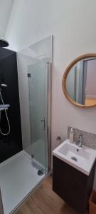 a bathroom with a shower and a sink and a mirror at Ring O Bells Hinton Blewett in Bristol