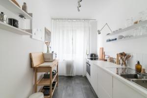 A kitchen or kitchenette at Allé Apartman Keszthely