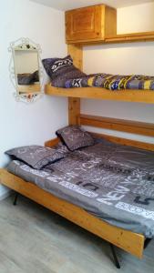 two bunk beds in a room with a mirror at Studio avec jardin clos et wifi a La Salle les Alpes in La Salle-les-Alpes