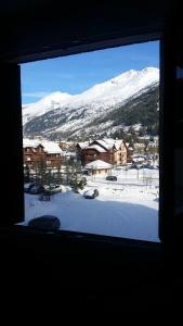 a view of a snow covered mountain from a window at Studio avec jardin clos et wifi a La Salle les Alpes in La Salle-les-Alpes