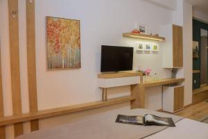 a living room with a flat screen tv on a wall at Holiday Meteora A in Kalabaka