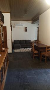 a living room with a table and a couch at Casa do Lago in Vila de Rei +6 photos