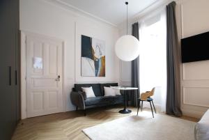 a living room with a couch and a table at Fingerprint Luxury Apartments in Zagreb