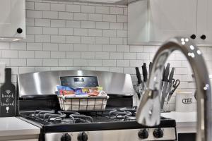a kitchen with a stove with a basket of food at *New* XquisiteMidCenturyM0d~ Condo *OTR* w/Parking in Cincinnati