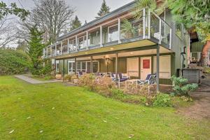 a house with a porch and chairs on a lawn at Edmonds Apartment with Private Wine Cellar! in Edmonds