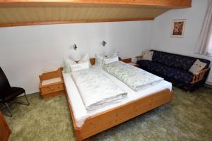 a bedroom with a bed and a couch at Haus Waldner in Aschau