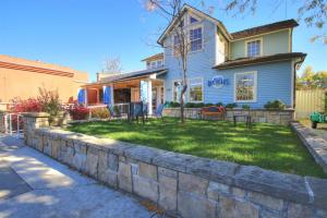 a house with a stone retaining wall in front of a yard at 18th Street D in Boise