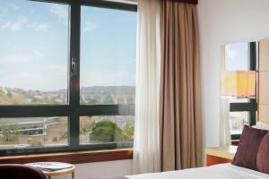 a hotel room with a view of the ocean at Hotel Acores Lisboa in Lisbon
