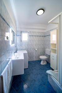 a bathroom with a sink and a toilet at Apartments Rajska Plaza (129) in Lopar